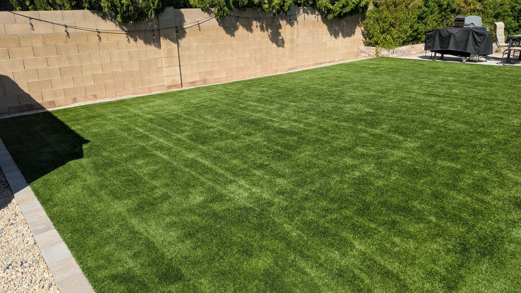 Freshly cleaned and groomed artificial turf backyard in the Phoenix metro by TurfHealth